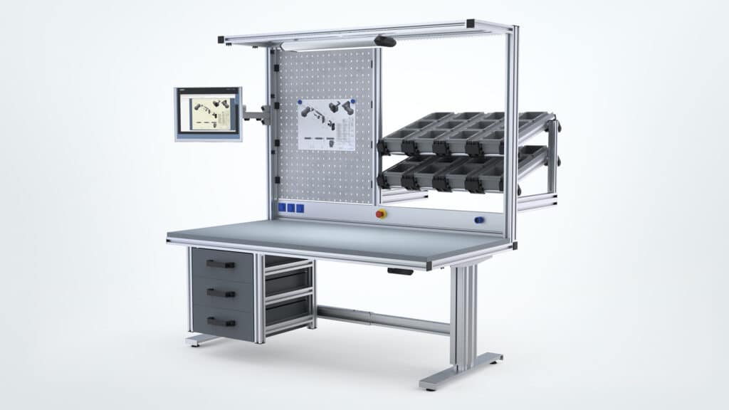 Ergonomic, modular workbench from Robotunits with individually adaptable material supply. Equipped with a stable work surface, integrated drawer solution, flexible tote storage, perforated back panel with tool holders, LED lighting, and a swivel screen for digital instructions. Ideal for efficient assembly and production processes.